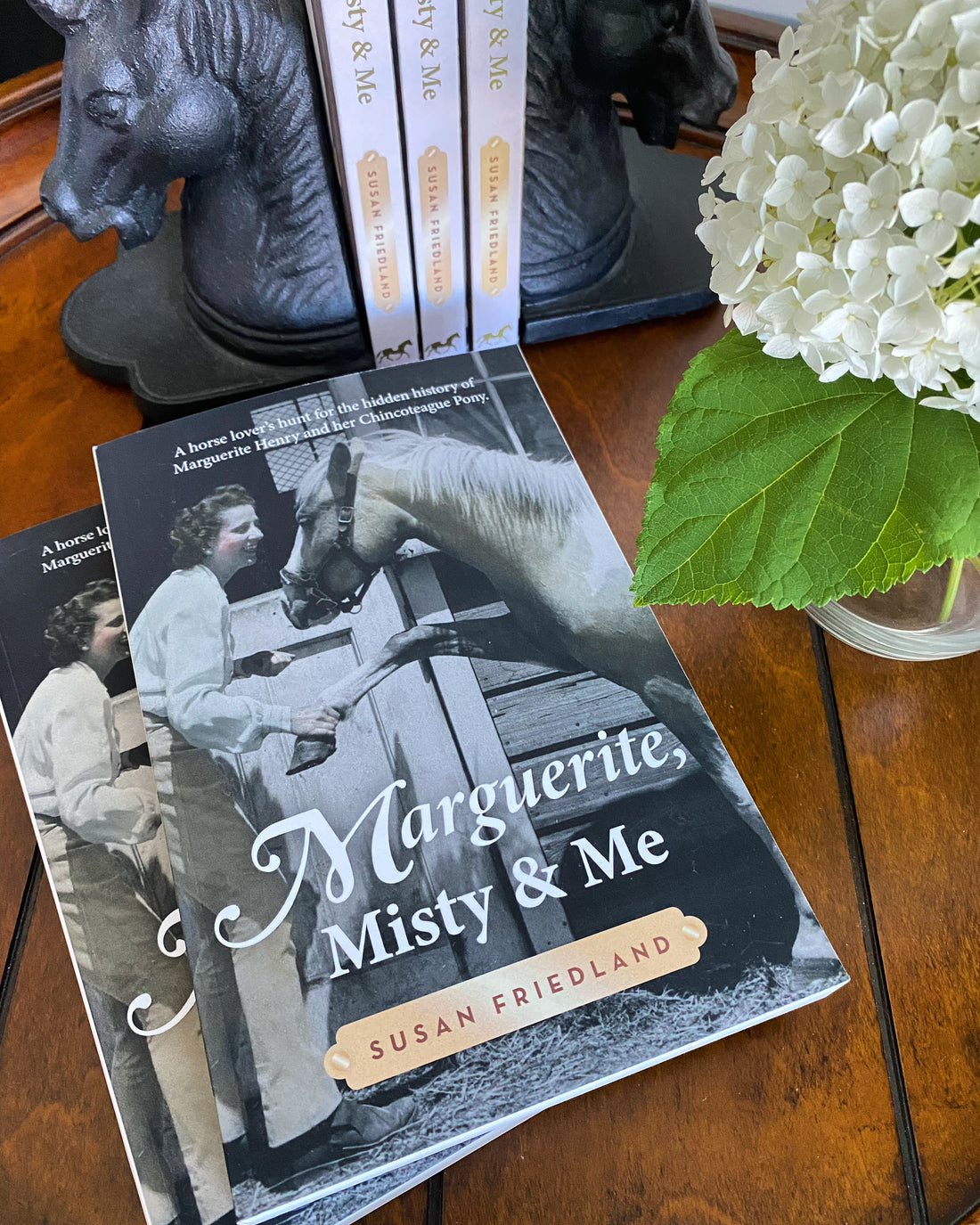 Marguerite Henry biography on nightstand with hydrangea