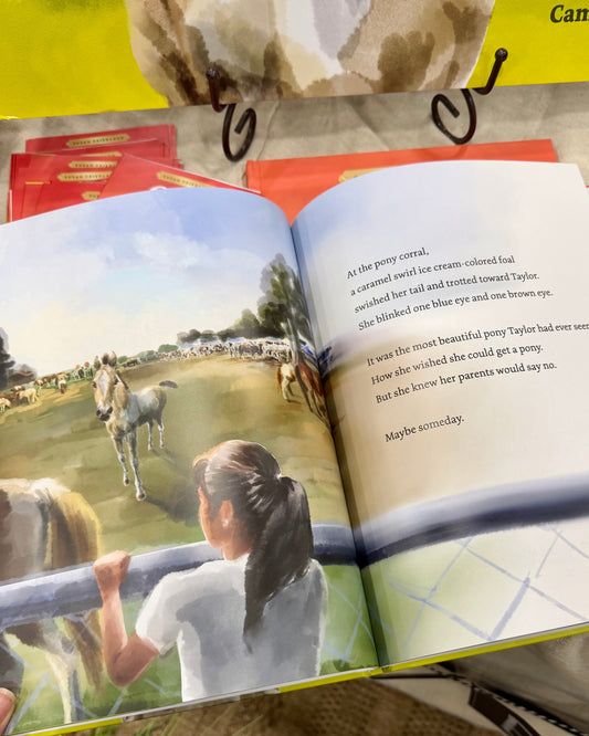 Interior page of girl looking at buckskin Chincoteague Foal at carnival grounds in pony picture book