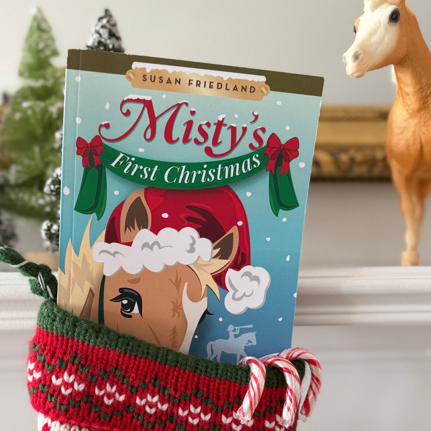 Christmas stocking with a book titled 'Misty's First Christmas' featuring a horse illustration.